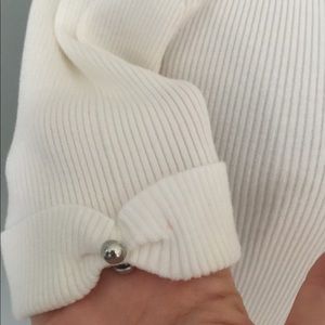 Off white elbow length top.